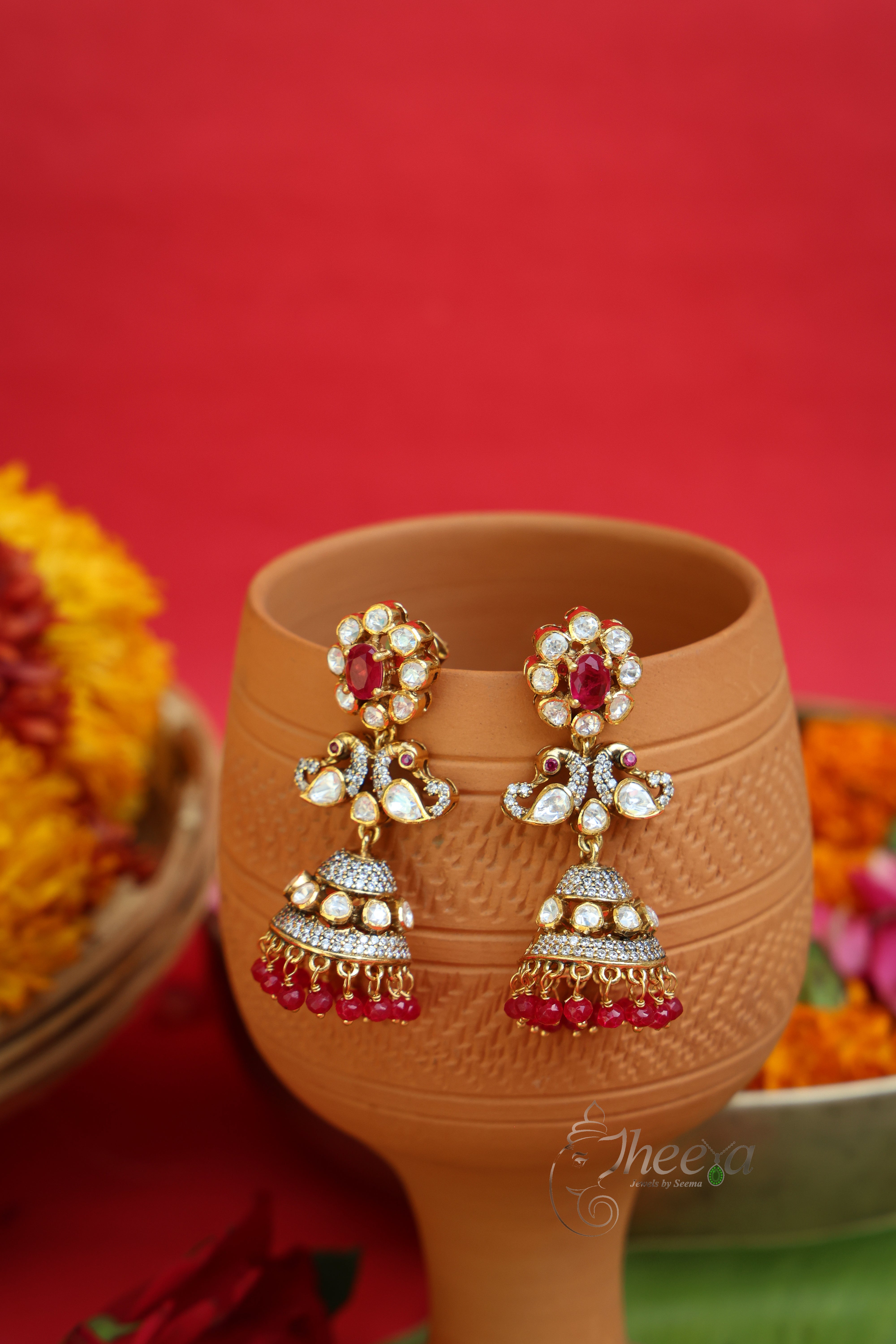 Gulnaar Shine Red Flower Jhumkas in Pure Silver with ruby red accents, front view.